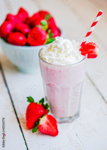 Strawberry milkshake on wooden background