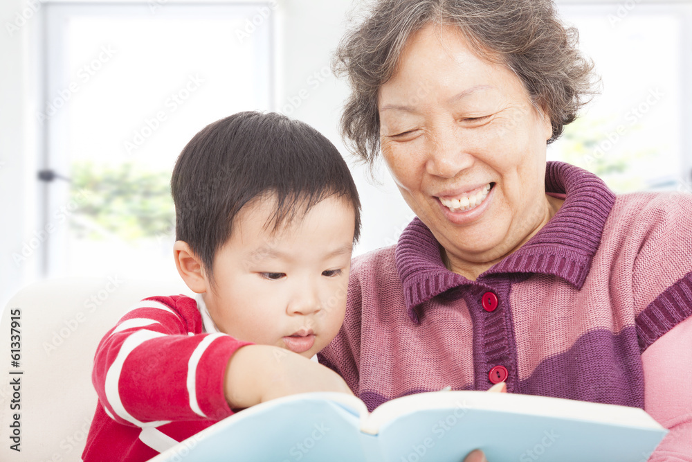 Fototapeta premium grandmother and grandson are reading story book together