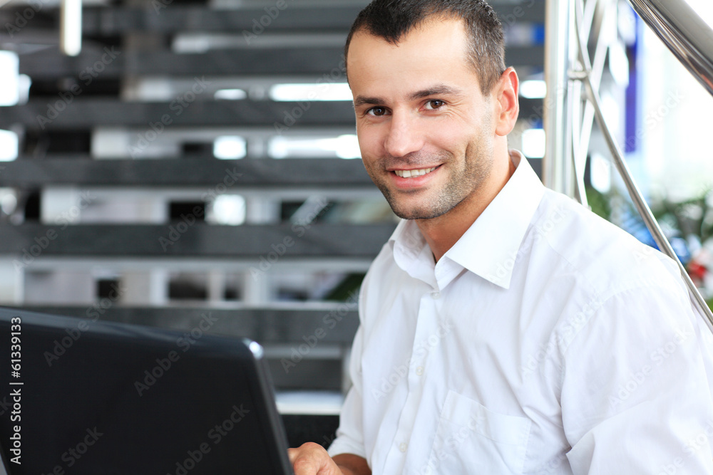 Businessman sitting on stairs and using laptop pc. Businessman sitting on stairs and using laptop pc.