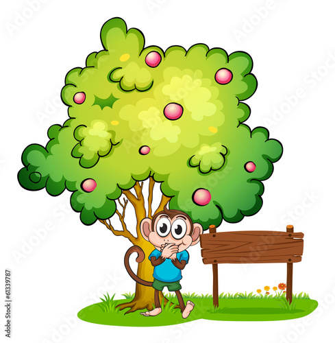 A monkey and an empty signboard under the tree