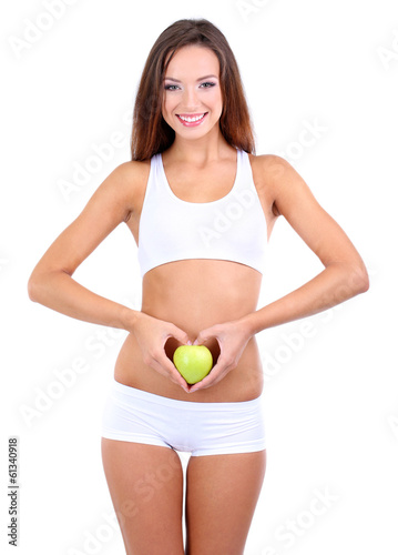 Beautiful young woman with green apple isolated on white © Africa Studio