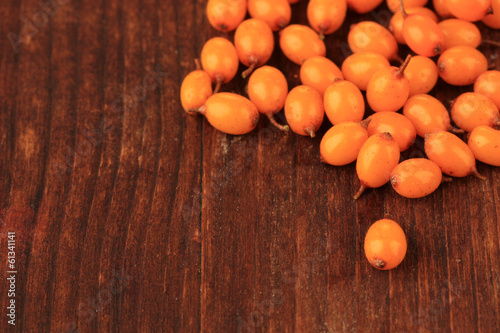 Sea buckthorn berries on wooden background photo