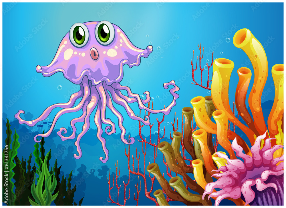 Fototapeta premium A cute jellyfish near the coral reefs