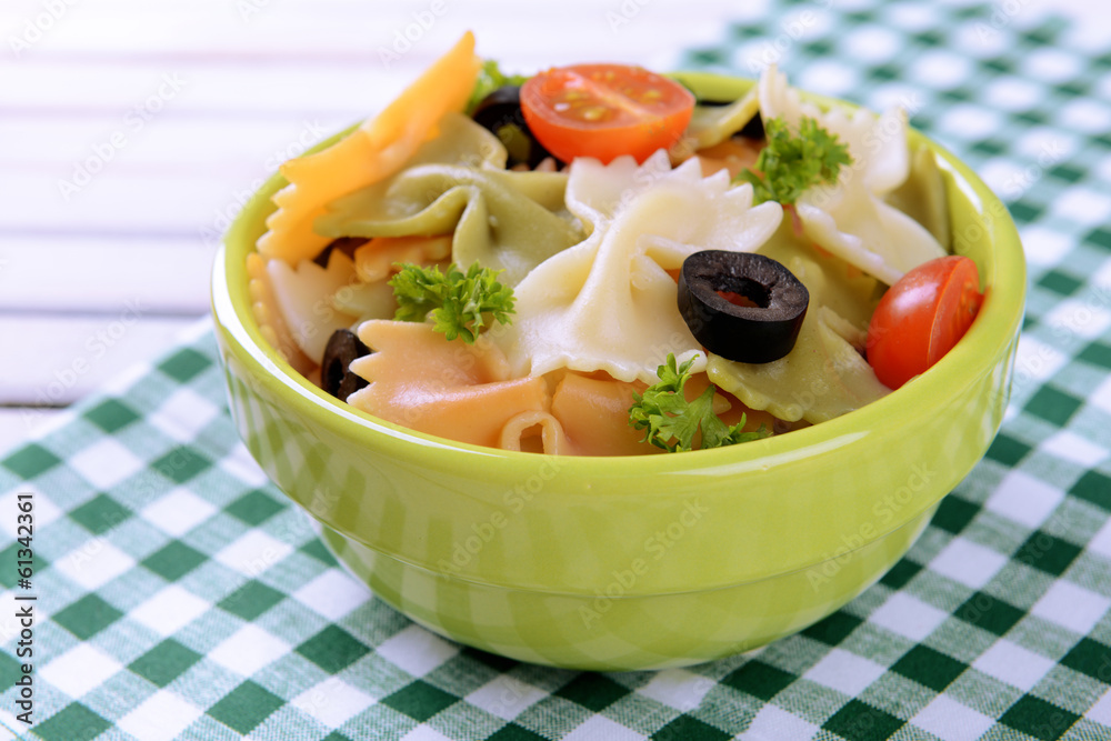 Delicious pasta with tomatoes on plate on table close-up Delicious pasta with tomatoes on plate on table close-up
