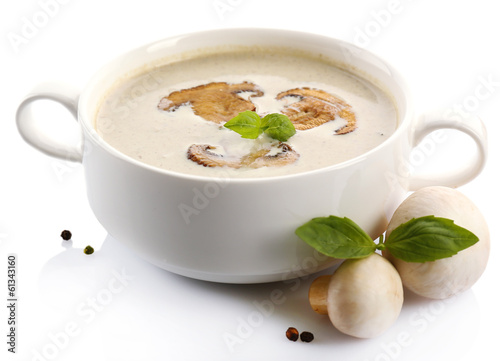 Mushroom soup in white bowl, on plate, isolated on white