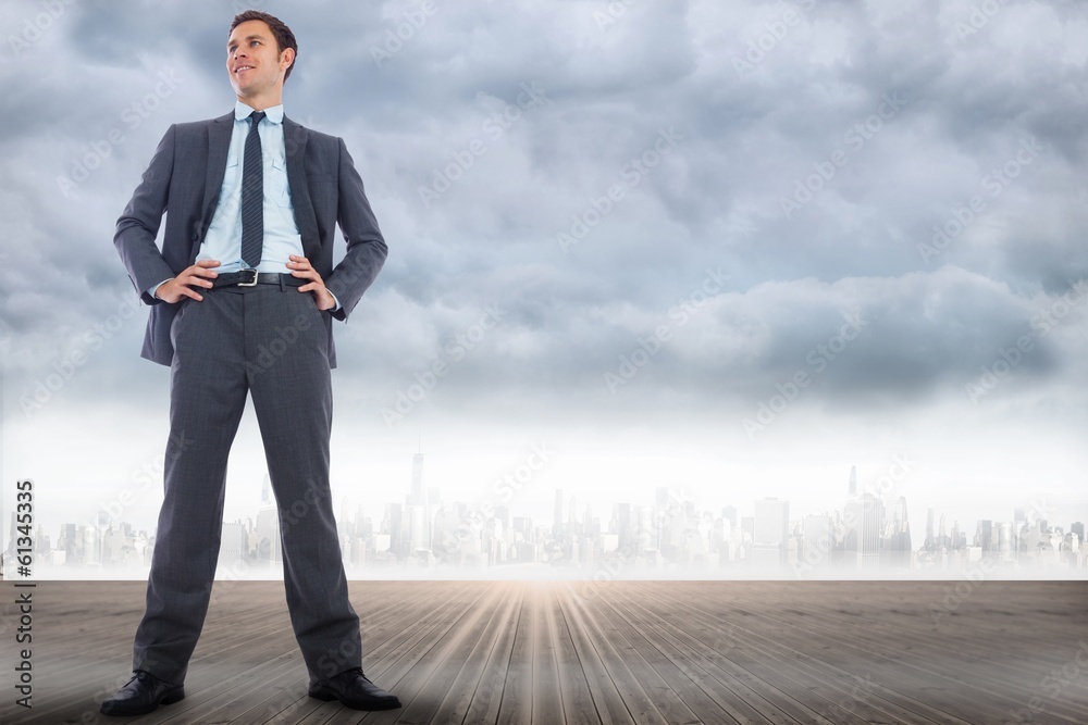 Composite image of happy businessman with hands on hips Composite image of happy businessman with hands on hips