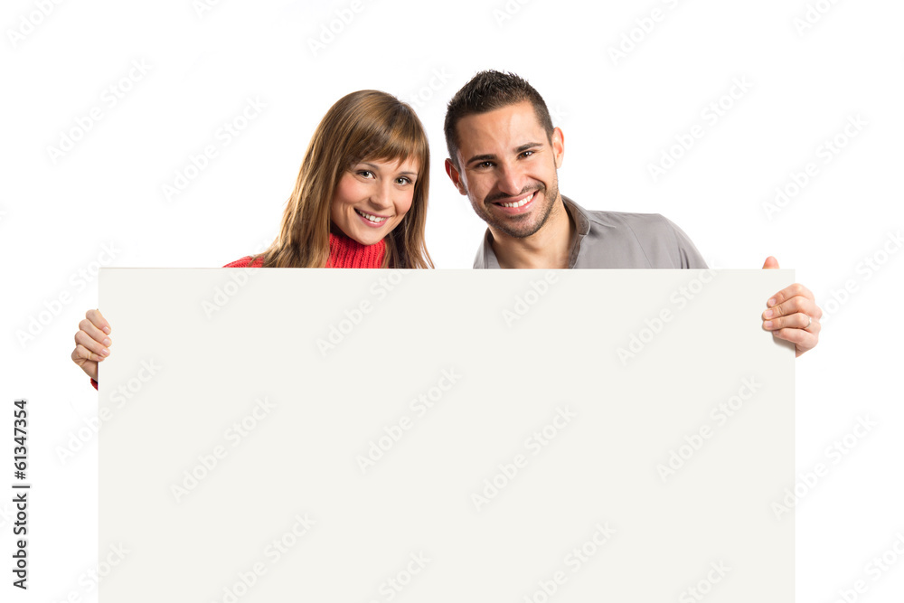 Couple holding placard over white background Couple holding placard over white background
