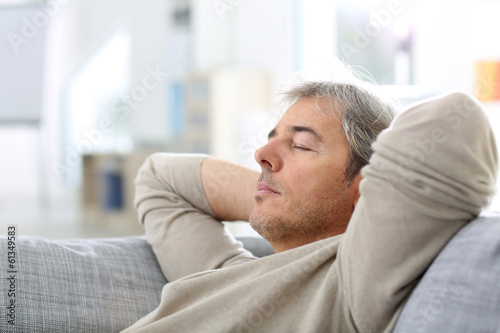 Man taking a nap in sofa at thome photo