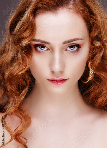 Portrait of beautiful girl with curly red hair, face closeup