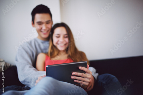 Happy teenage couple movie on digital tablet