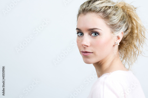 Beautiful young blonde woman looking at the camera