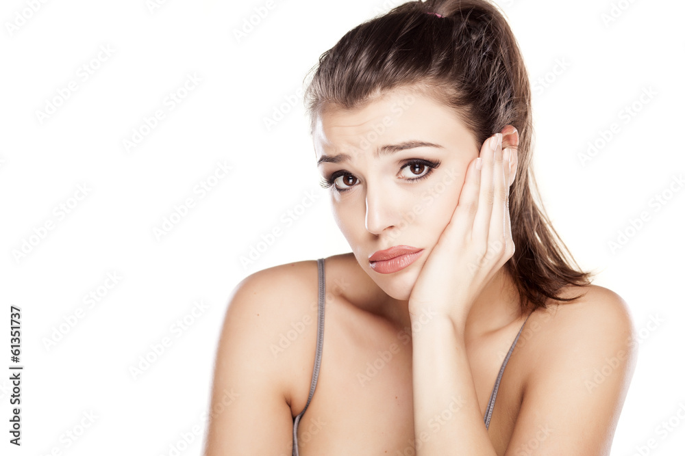pretty sad young woman on a white background pretty sad young woman on a white background