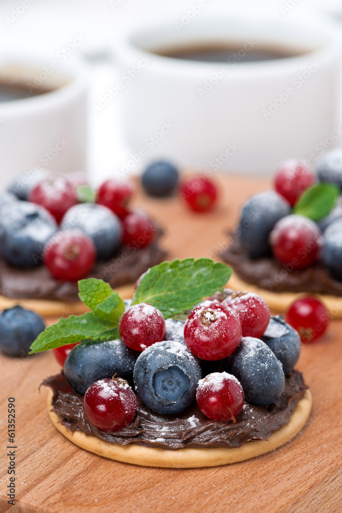 cake with chocolate cream and fresh berries on a wooden board cake with chocolate cream and fresh berries on a wooden board