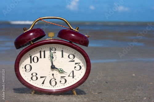 Vintage clock on a beach