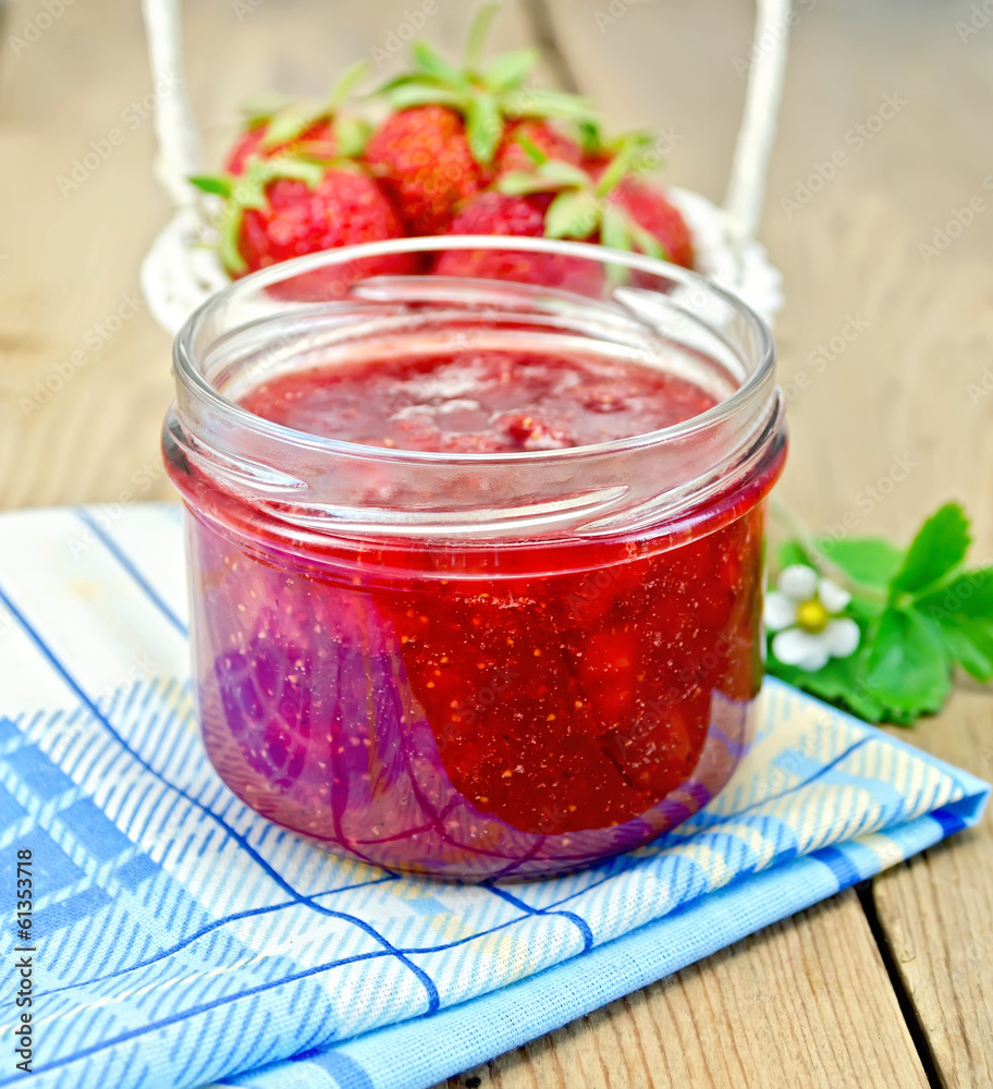 Jam of strawberry with a basket on the board Jam of strawberry with a basket on the board