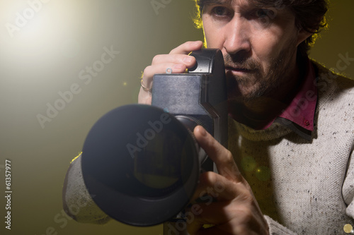 Man with retro camera shoots the film stress