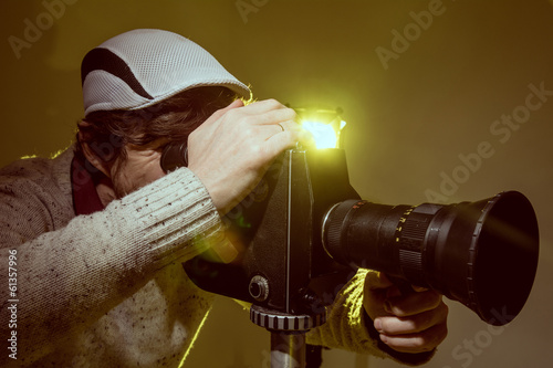 Man with old film movie camera