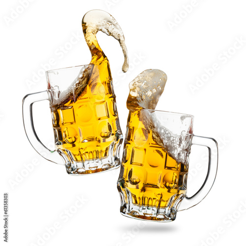 Clink glasses of beers with a splash isolated