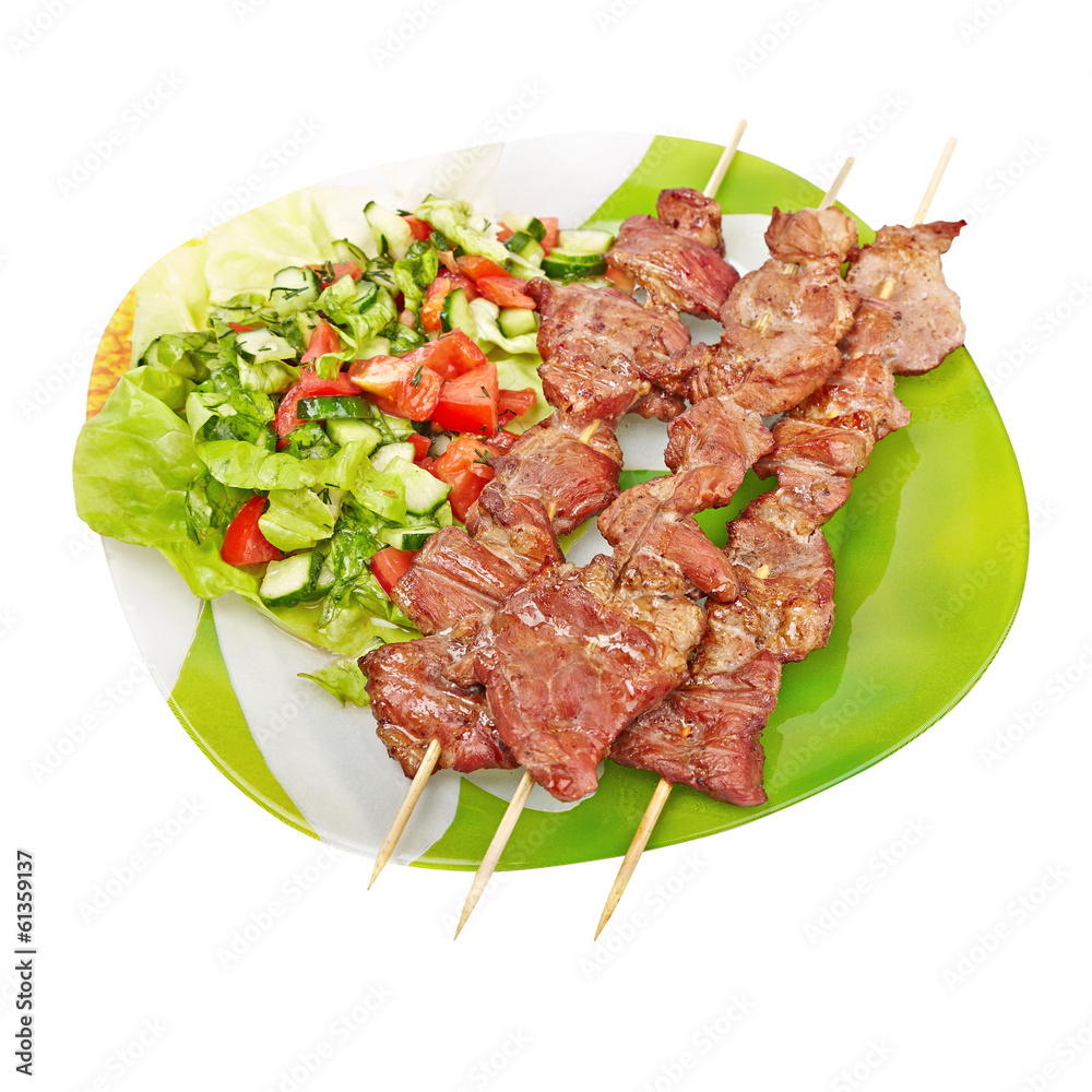 kebab and salad on a green plate, isolated on white background