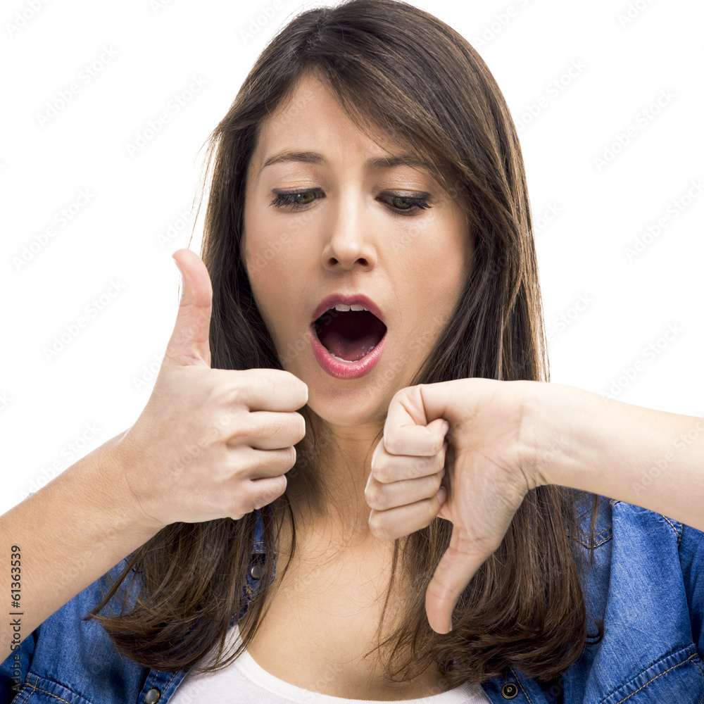 Beautiful woman confused making thumbs up and down Beautiful woman confused making thumbs up and down