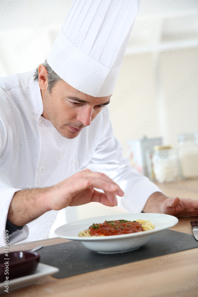 Chef in kitchen preparing italian dish Chef in kitchen preparing italian dish
