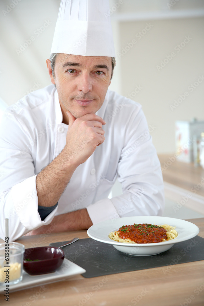 Portrait of chef in kitchen preparing italian dish Portrait of chef in kitchen preparing italian dish