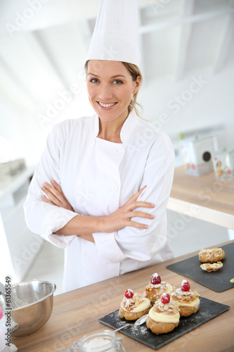 Successful woman confectioner in professional kitchen photo