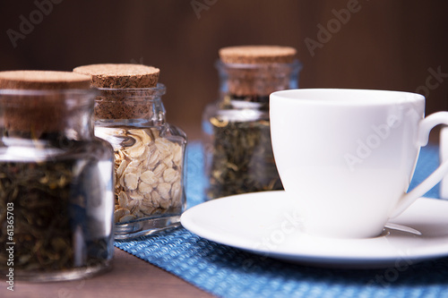 A white cup and three sealed jars