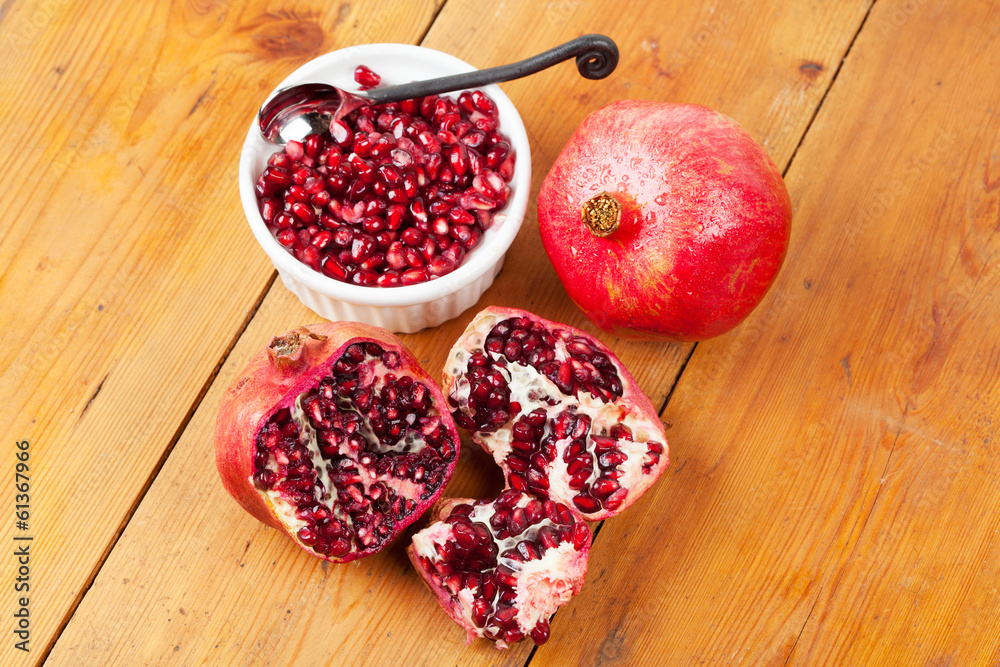 Cut open and whole pomegranate fruit Cut open and whole pomegranate fruit
