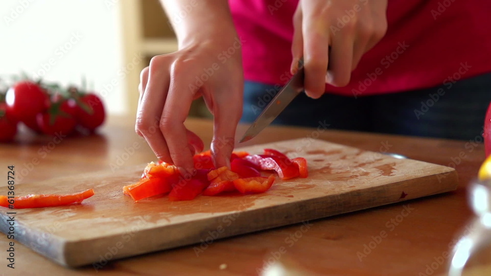 Slicing red pepper on chopping board