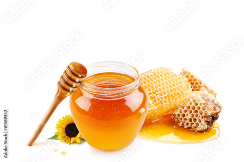 Honey in glass jar and honeycombs wax
