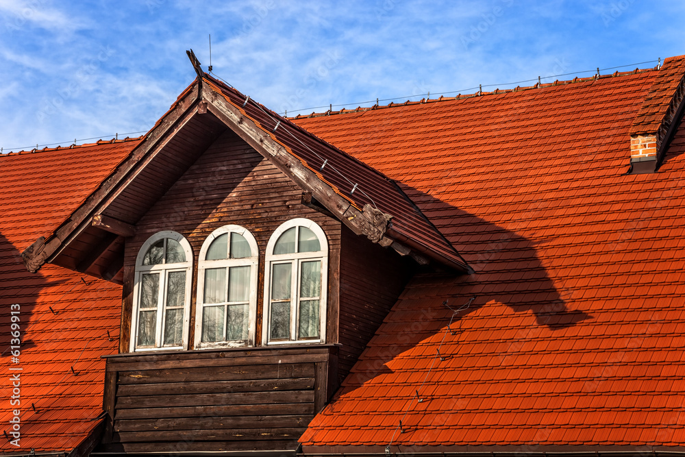 Old attic windows in a tiled roof. Old attic windows in a tiled roof.