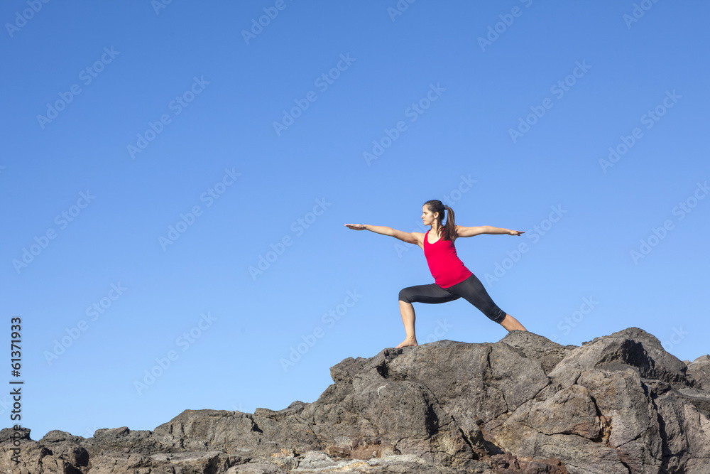 Young woman practicing yoga warrior pose outdoor Young woman practicing yoga warrior pose outdoor