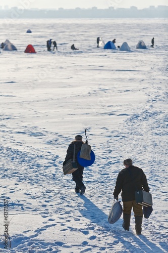 Ice Fishing on winter snow lake