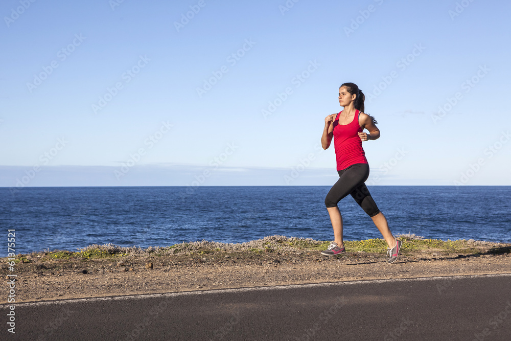 Young woman jogging along the seacoast