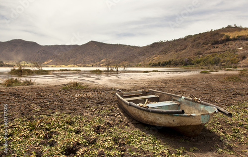 old boat on dry lake photo