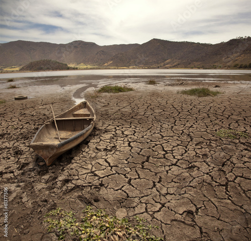 old boat on dry lake photo