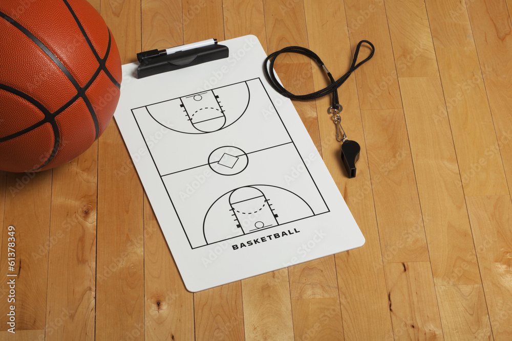 Fototapeta premium Basketball with coach's clipboard and whistle on wooden floor