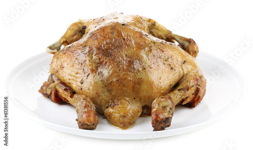 Whole roasted chicken on plate, isolated on white