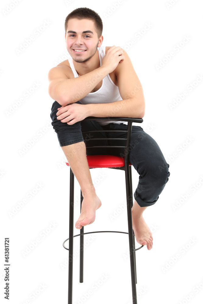 Handsome young man sitting on chair isolated on white Handsome young man sitting on chair isolated on white