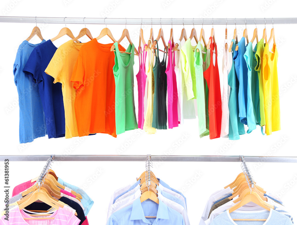 Different clothes on hangers, on gray background Different clothes on hangers, on gray background