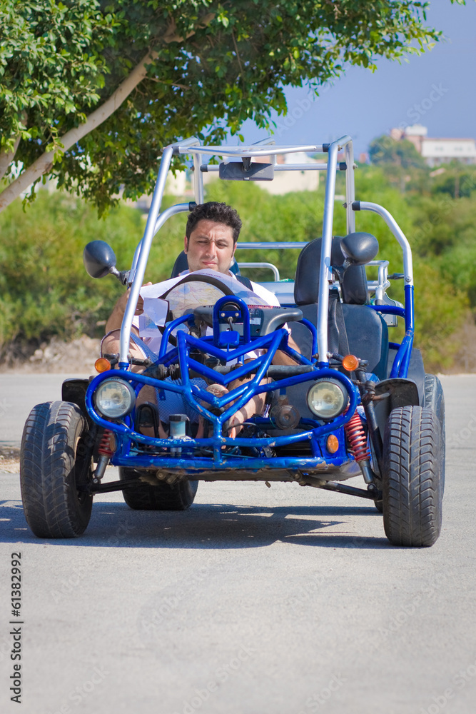 Man with map sits in buggy Man with map sits in buggy