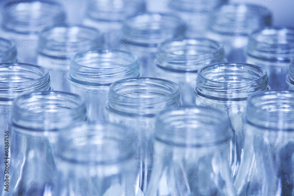 Rows of glass bottles ready for recycling, shallow depth of fiel