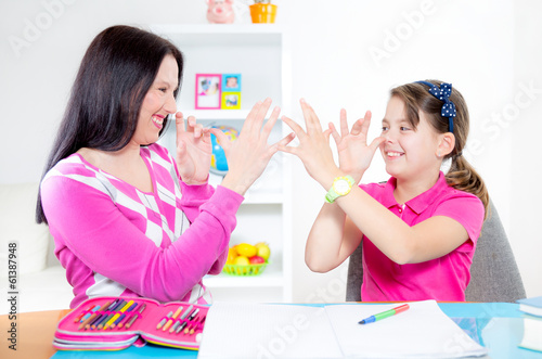 Mother helps daughter of homework and have fun