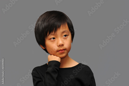 Smart Asian boy thinking photo