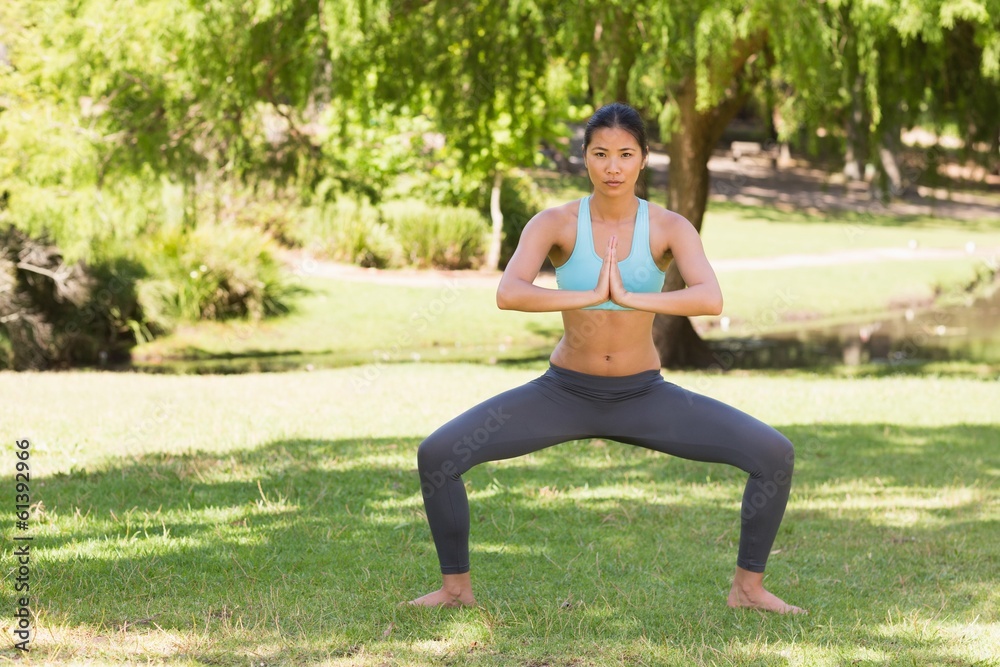 Healthy and beautiful woman with joined hands in park Healthy and beautiful woman with joined hands in park