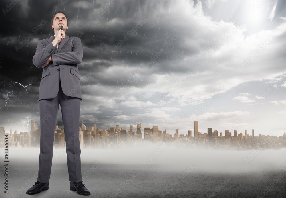 Composite image of thinking businessman holding glasses Composite image of thinking businessman holding glasses