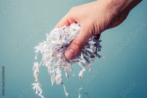 Bild auf Leinwand Hand with shredded paper