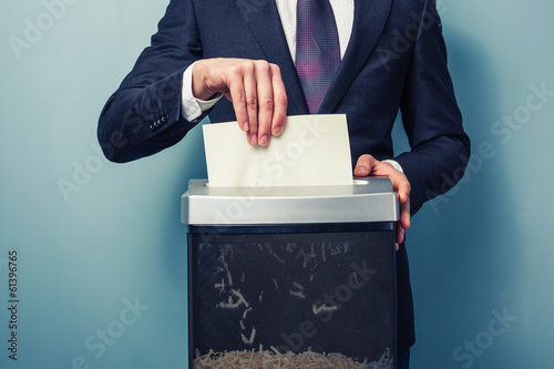 Businessman shredding documents photo