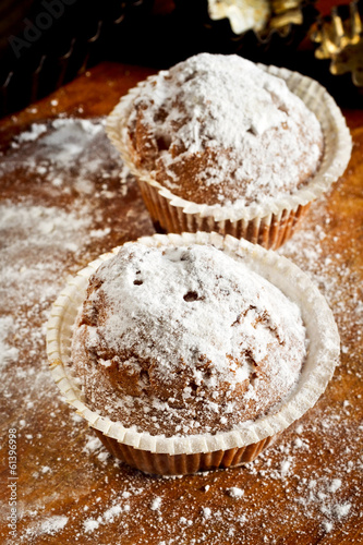 Small cherry cakes with a sugar powder on a table in the kitchen